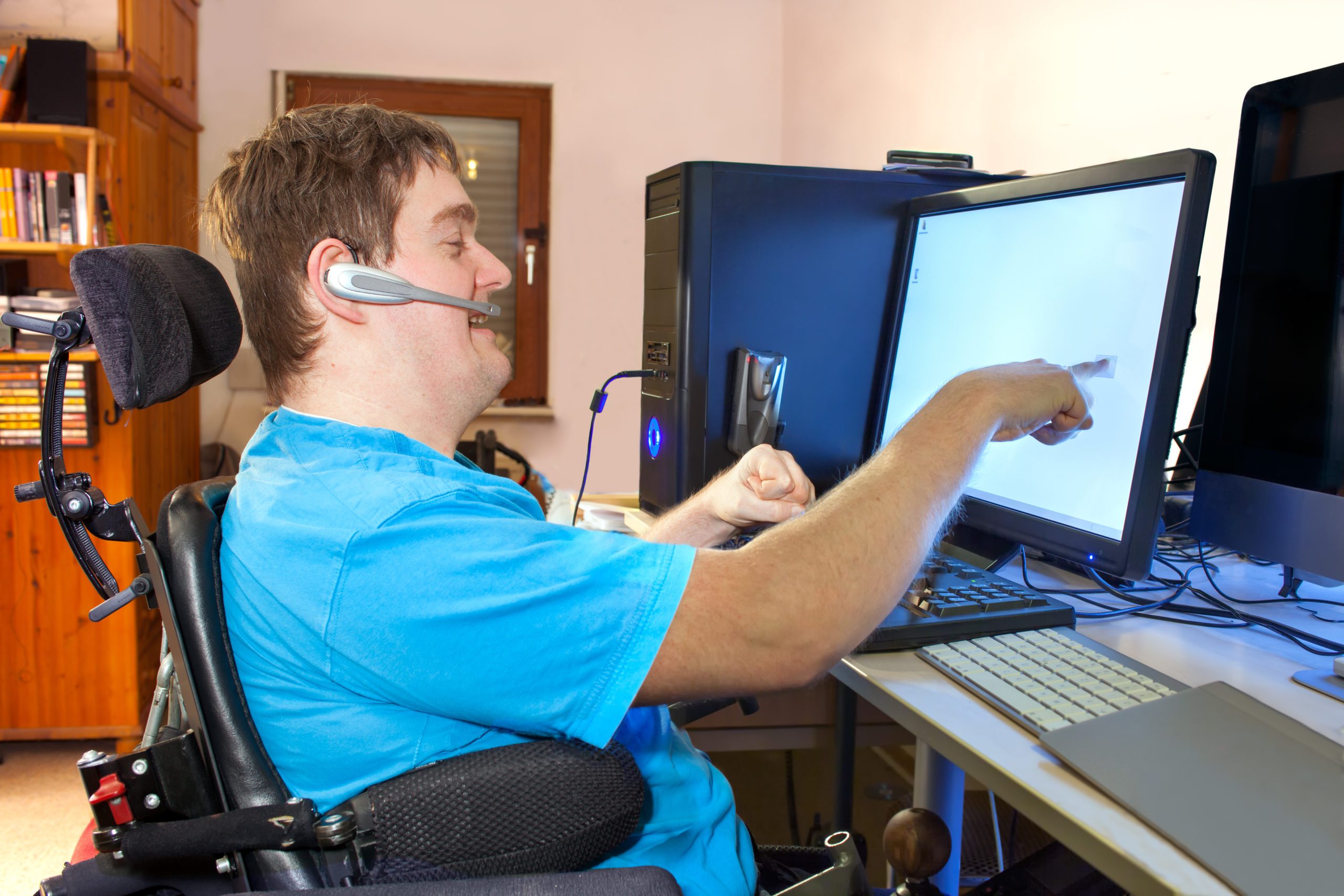 Man with cerebral palsy using a computer.